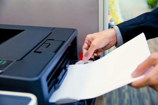 Businessmen putt a paper on photocopiers.