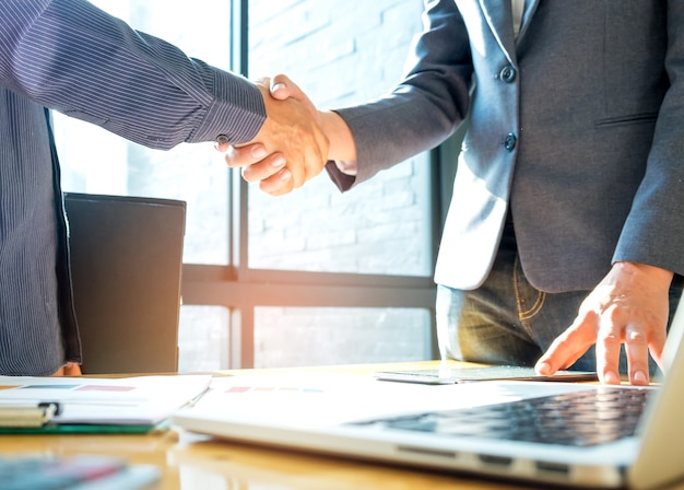 Businessmen shake hands after agreeing