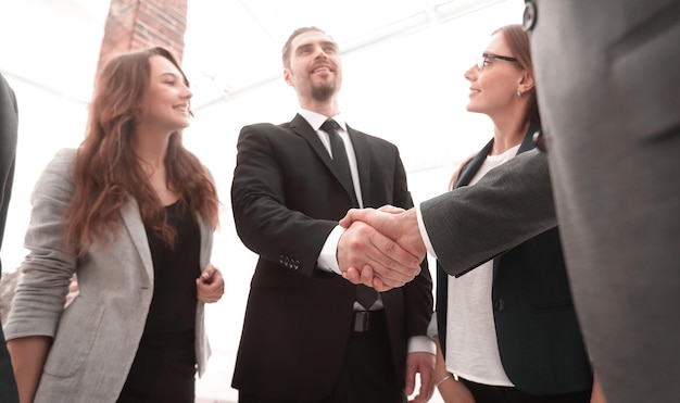 Businessmen shaking hands in conference room