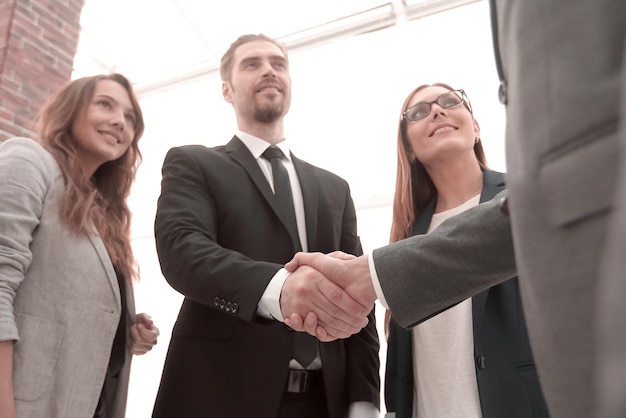 Businessmen shaking hands in conference room