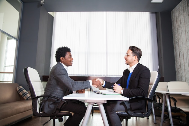 Businessmen shaking hands each other