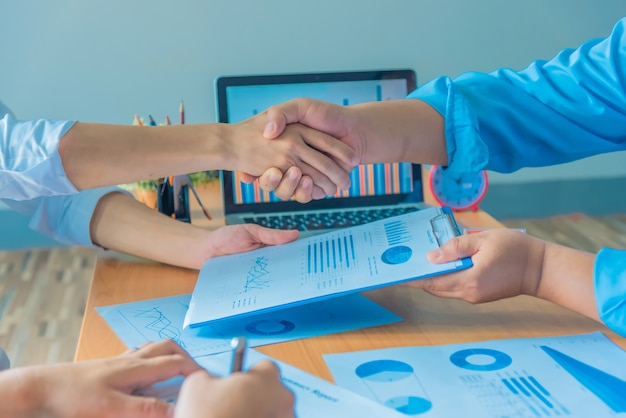 Businessmen shaking hands during a meeting.