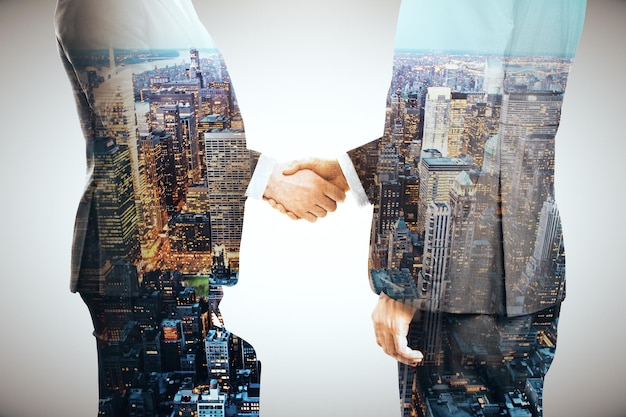 Businessmen shaking hands multiexposure