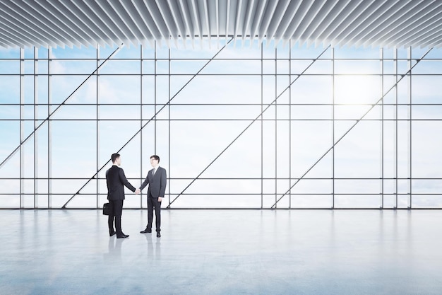 Businessmen shaking hands in office