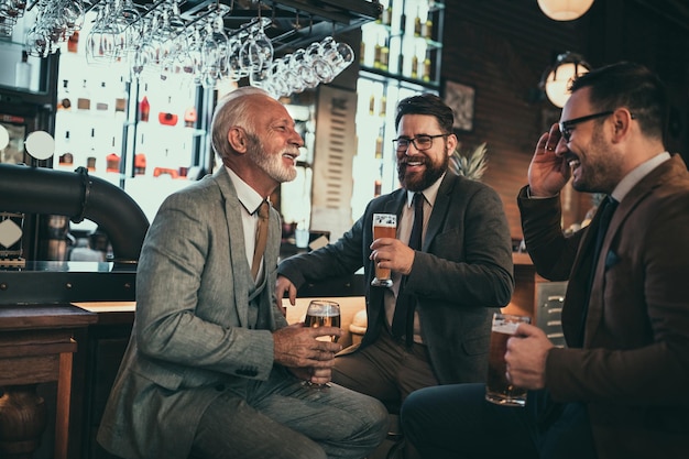 Businessmen socializing at the bar after work