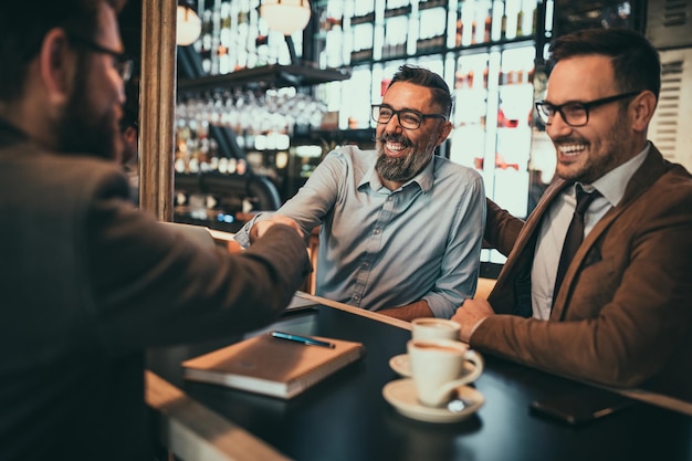 Businessmen socializing at the bar