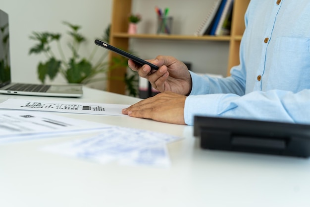 Businessmen use phones to scan bar code to pay credit card bills after receiving invoices