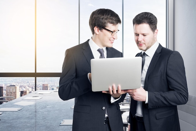 Businessmen using laptop