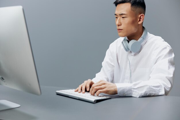 Businessmen in a white shirt with headphones sits in the office\
lifestyle work