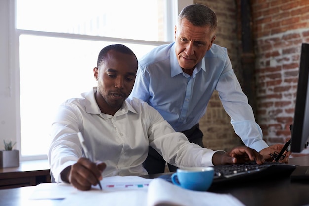 Businessmen Working On Computer In Office