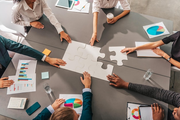 Businessmen working together to build a puzzle as teamwork partnership and integration concept