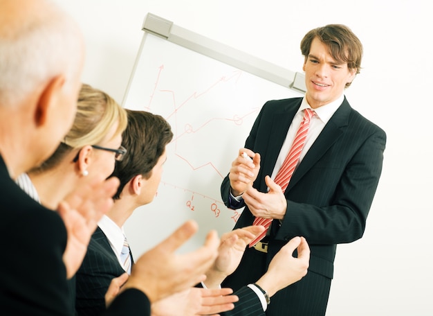 businesspeople applauding at a meeting