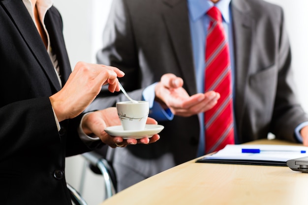 businesspeople in business office drink coffee