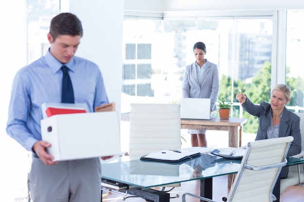 Businesspeople carrying their belongings in box