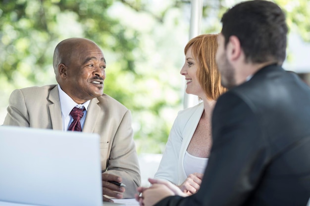 Businesspeople discussing work at business lunch