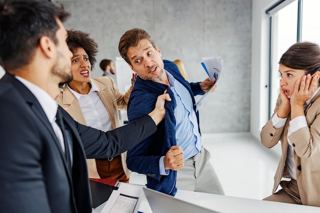 A businesspeople fighting and screaming in the office