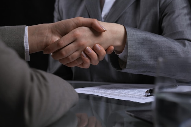 Businesspeople or lawyers shaking hands at meeting endless. Low key lighting.