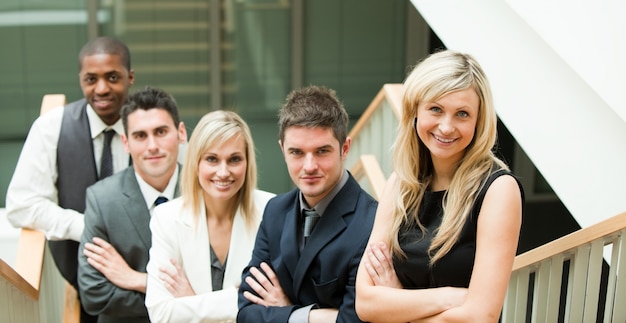 Businesspeople looking at the camera with folded arms