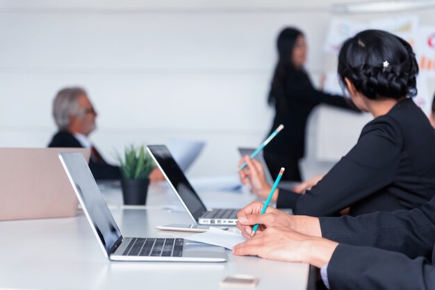 Businesspeople meeting and discussing with colleagues in conference room