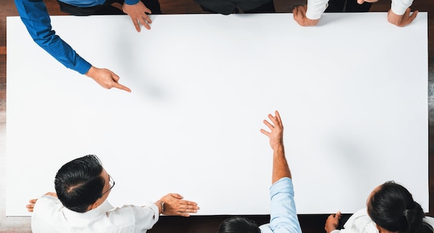 Photo businesspeople on meeting table pointing to empty space prudent