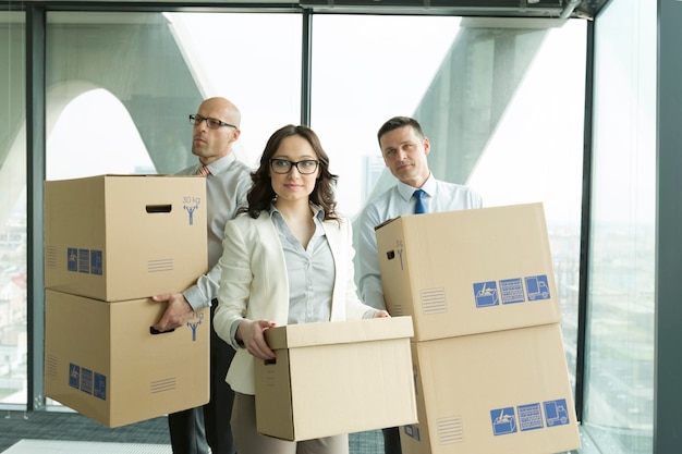 Businesspeople in office with cardboard boxes