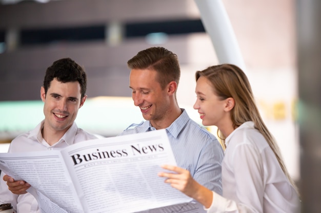 businesspeople reading business newspaper