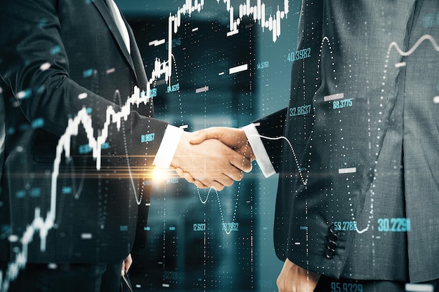 Фото Бизнесмены пожимают друг другу руки и светятся абстрактными финансовыми диаграммами