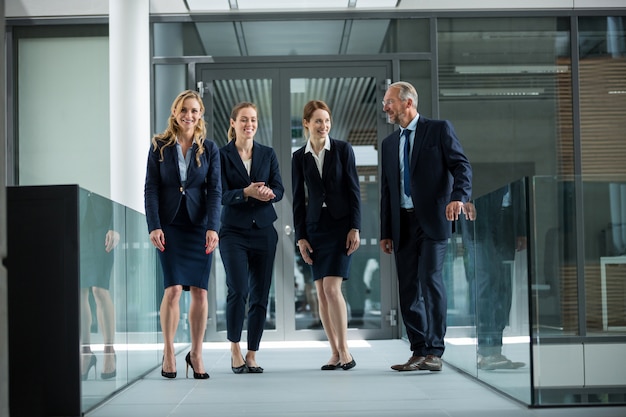 Businesspeople standing and having a discussion in office