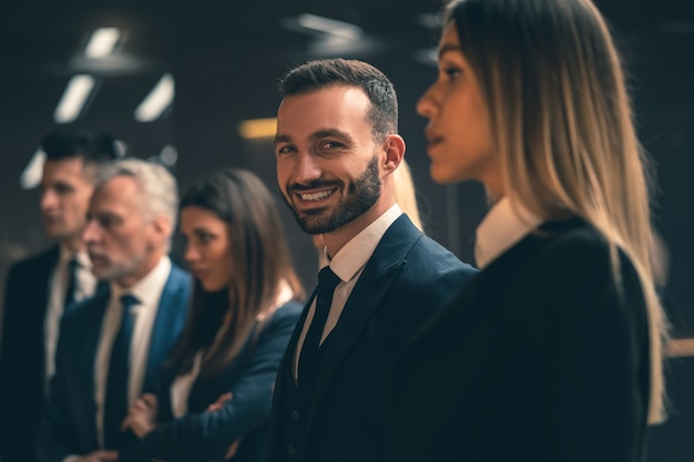 The businesspeople standing indoor