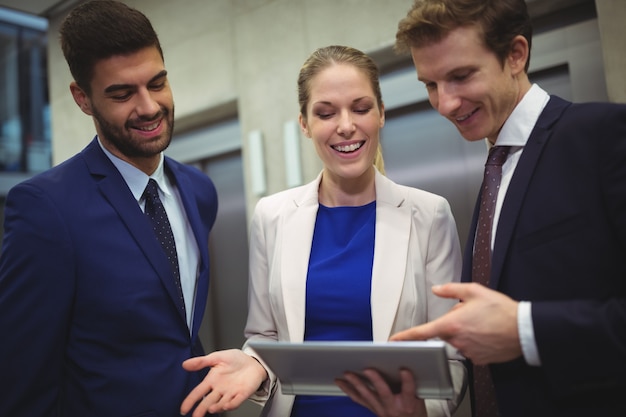 Businesspeople using digital tablet