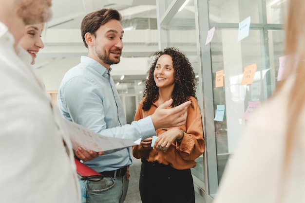 businesspeople using sticky notes agile methodology for productivity working in modern office