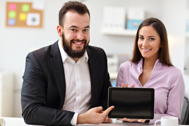 Businesspeople using tablet in office