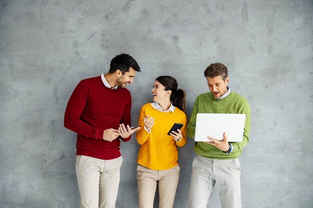 Businesspeople using technologies and posing at empty space