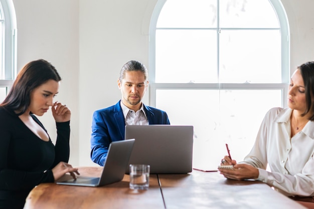 Businesspeople with laptop in a meeting