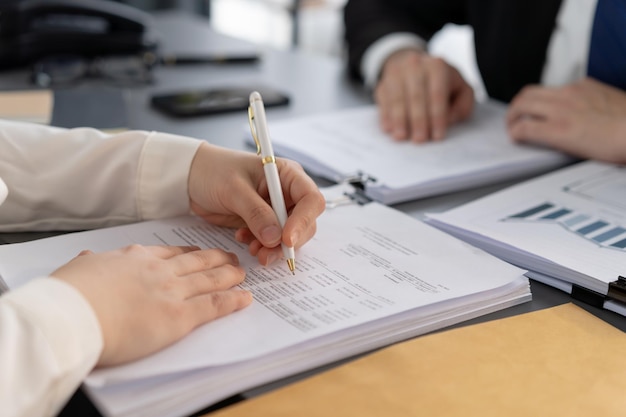 Businesspeople working in the office on official corporate papers Equilibrium