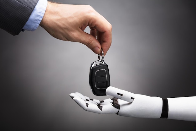 Businessperson Giving Car Key To Robot