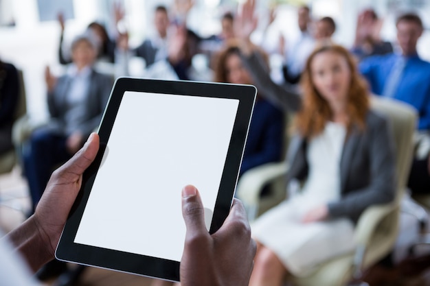 Businessperson using digital tablet during meeting