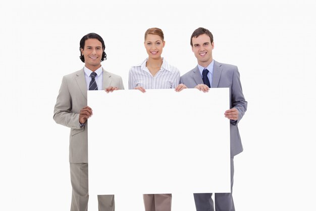 Businessteam holding blank sign