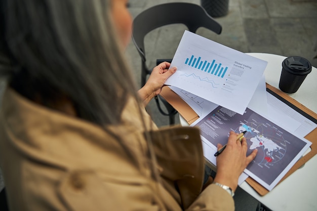 Businesswoman analyzing information about global trading transfers