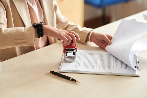 Businesswoman Applying Company Seal