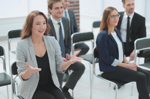 Businesswoman asking question during her colleagues presentation