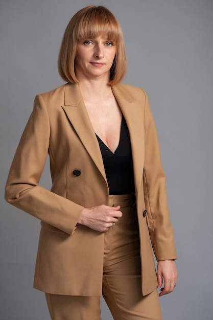 Businesswoman beige formal suit on background