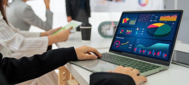 Businesswoman in business meeting using laptop computer proficiently at office