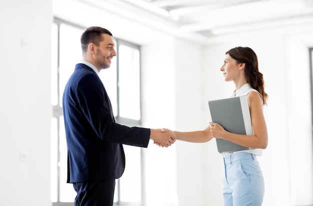 businesswoman and businessman shake hands