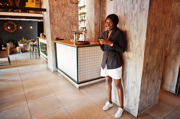 Businesswoman in cafe with mobile phone