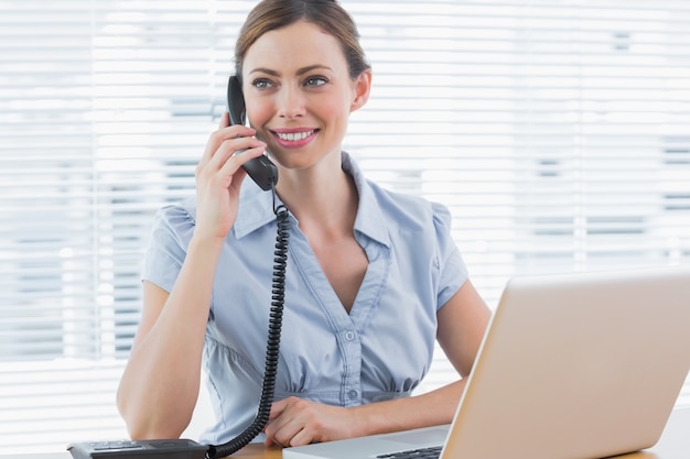 Businesswoman calling and looking away