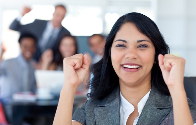 Businesswoman celebrating a success in office