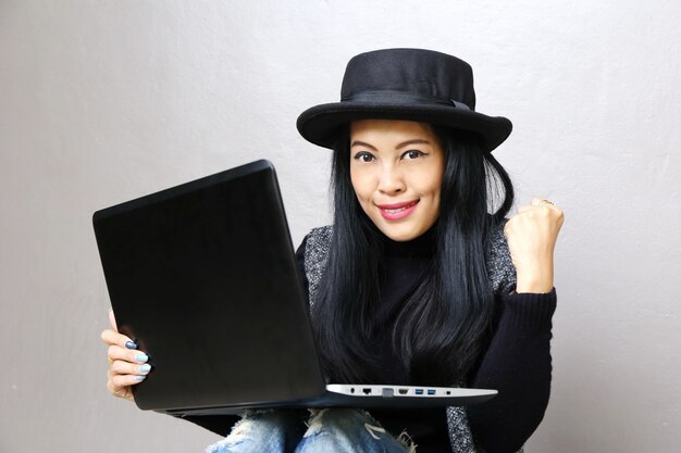 Businesswoman, Charming beautiful tan skin Asian business chic woman hand work on laptop and success  hand up 