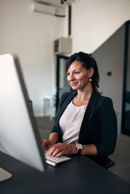 Businesswoman chatting online.