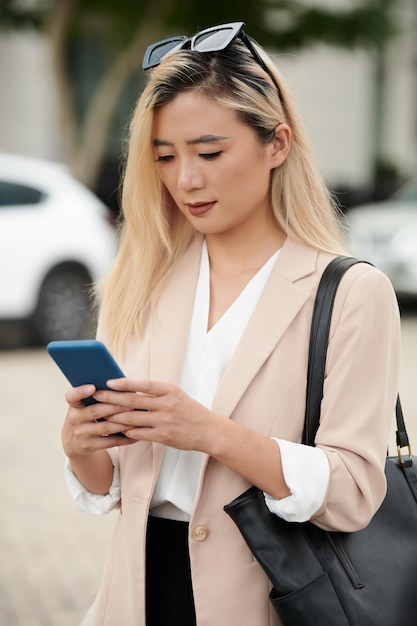 Businesswoman Checking Messages from Colleagues